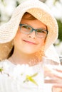 Summer little girl in straw hat drinking water outdoor portrait.