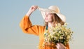 Summer look of a beautiful young woman in hat and red dress with a bouquet of white flowers Royalty Free Stock Photo