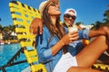 Summer love. an affectionate young couple enjoying a few drinks poolside. Royalty Free Stock Photo