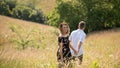 Summer love couple walking in grassy field Royalty Free Stock Photo