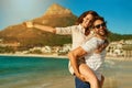 Summer, the love inspired season. a happy young couple enjoying a piggyback ride at the beach. Royalty Free Stock Photo