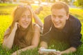 Summer, love and people concept - close up of happy teenage couple lying on grass with earphones and listening to music. Royalty Free Stock Photo
