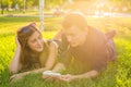 Summer, love and people concept - close up of happy teenage couple lying on grass with earphones and listening to music. Royalty Free Stock Photo