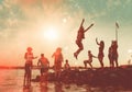 man group fun happiness youth jump vacation sunset summer ocean friend. Generative AI.