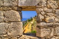 Summer mediterranean landscape - view from the loophole of the tower to the Klis Fortress near the city of Split Royalty Free Stock Photo