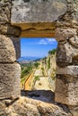 Summer mediterranean landscape - view from the loophole of the tower to the Klis Fortress near the city of Split Royalty Free Stock Photo