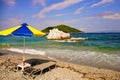 Sun umbrella and beds at Milia beach, Skopelos, Greece Royalty Free Stock Photo