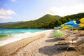 Sun umbrella and beds at Milia beach, Skopelos, Greece Royalty Free Stock Photo