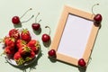 Summer mockup with wooden square frame, cherries and strawberries. Summer berry background. Flat lay. Summer concept Royalty Free Stock Photo