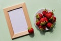 Summer mockup with wooden square frame, strawberries. Summer berry background. Flat lay. Summer concept.fruit frame Royalty Free Stock Photo