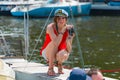 Summer mood: a girl in red blouse taking pictures at the yacht club Royalty Free Stock Photo