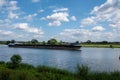 Summer morning - a dutch dike landscape at the river Maas with boat. Agricultural landscape