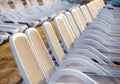 Summer morning empty sunny beach with white plastic chairs