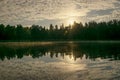 Summer morning landscape on the lake, light fog on the water surface, beautiful clouds and wonderful reflections in the lake Royalty Free Stock Photo