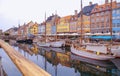 Summer morning view of Nyhavn pier with color buildings, ships, yachts and other boats in the old part of town of Copenhagen,