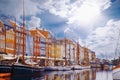 Summer morning view of Nyhavn pier with color buildings, ships, yachts and other boats in the old part of town of Copenhagen,