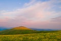 Summer mountain landscape: the mountain top glows with light at Royalty Free Stock Photo