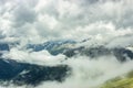 Summer mountains green grass snow and stormy sky landscape