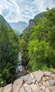 Summer mountains countryside view from Elenski Skok ancient small pedestrian stone bridge above stream in deep gorge. North Royalty Free Stock Photo