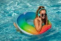 Summer music. Gorgeous young woman posing in bikini near pool, listen to music. Summer Vacation. Enjoying Woman in Royalty Free Stock Photo