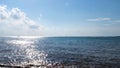 Summer natural landscape with rippled sea surface shining bright on blue cloudy sky background. Concept. Sun reflected Royalty Free Stock Photo