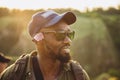 In summer in nature. Close-up young african man walking, strolling alone in forest, meadow, field. Amazing landscape Royalty Free Stock Photo