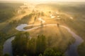 Summer nature landscape aerial view. Foggy morning river in sunlight. Sunny riverside from above. Amazing nature scene at misty