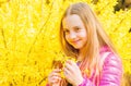 Summer nature. Natural beauty. Childhood happiness. happy child with yellow bush bloom. little girl smell blooming Royalty Free Stock Photo