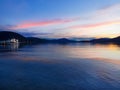 Summer night mountain landscape with boat on Lake Woerther, Carinthia, Austria. Royalty Free Stock Photo