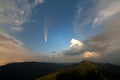 Summer night in mountains with starry dark blue cloudy sky and C/2020 F3 NEOWISE comet with light tail Royalty Free Stock Photo