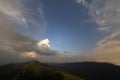 Summer night in mountains. Starry dark blue sky and white clouds at sunset over mountain range. Royalty Free Stock Photo