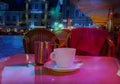 Summer night Street cafe bokeh blurring city light evening restaurant table cup of coffee on top view candle lamp light reflecti