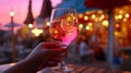 glass of wine in hand on evening pink sunset summer beach restaurant beach , romantic couple silhouette