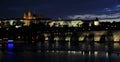 Summer night view of Charles Bridge over the Vltava in the historical part of Prague Royalty Free Stock Photo