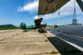 Old helicopter rotor plane on a green airfield.