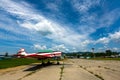 Old helicopter rotor plane on a green airfield.