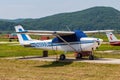 Old helicopter rotor plane on a green airfield.