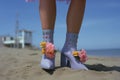 Hot Summer beach with legs and cute colorful girly flower printed motif plastic boots - generative AI