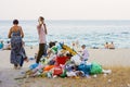 Summer 2019, Odessa, Ukraine A pile of garbage on the urban sand beach next to people relaxing on the sea. The local economy is