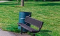 Summer in Omaha, a bench with a bird and a trash can at Ed Zorinsky Lake Park Omaha NE