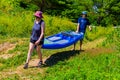 Summer in Omaha, Kayaks heading to the beach by the waters edge at Ed Zorinsky lake park, Omaha, Nebraska, USA