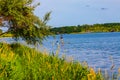 Summer in Omaha, Isolated paddle boater at water`s edge at Ed Zorinsky lake park, Omaha, Nebraska, USA