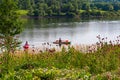 Summer in Omaha, Two boaters in kayaks with Shoreline and sky reflections in the lake at Ed Zorinsky Lake Park Omaha NE