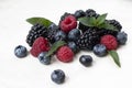 Summer organic berries. healthy food. mixed fresh berries. blackberry, blueberry. raspberry and mint leaves Royalty Free Stock Photo