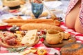 Summer outdoor picnic. Woman hold the wooden honey spoon, honey drips from it to pot. Instagram content Royalty Free Stock Photo