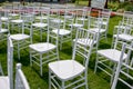 Summer outdoor wedding ceremony decoration. White classic chairs to accommodate guests at the ceremony Royalty Free Stock Photo