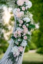 Summer outdoor wedding ceremony decoration. Decoration of white roses, hydrangeas and gypsophila on the arch for the wedding cerem Royalty Free Stock Photo