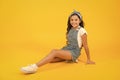 Summer outfit concept. Girl long curly hair sit relaxing. Fashion trend. Little fashionista. Carefree happy childhood Royalty Free Stock Photo