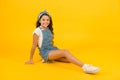 Summer outfit concept. Girl long curly hair sit relaxing. Fashion trend. Little fashionista. Carefree happy childhood Royalty Free Stock Photo