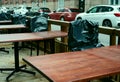 Summer is over, plastic-covered chairs in empty street cafe